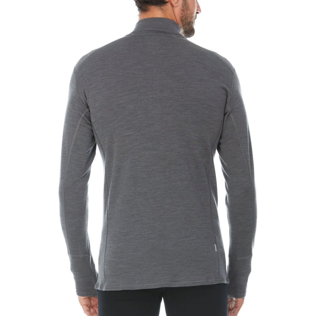 A man models the merino wool midweight quarter zip sweater, complete with flat-lock seams and thumbholes. 