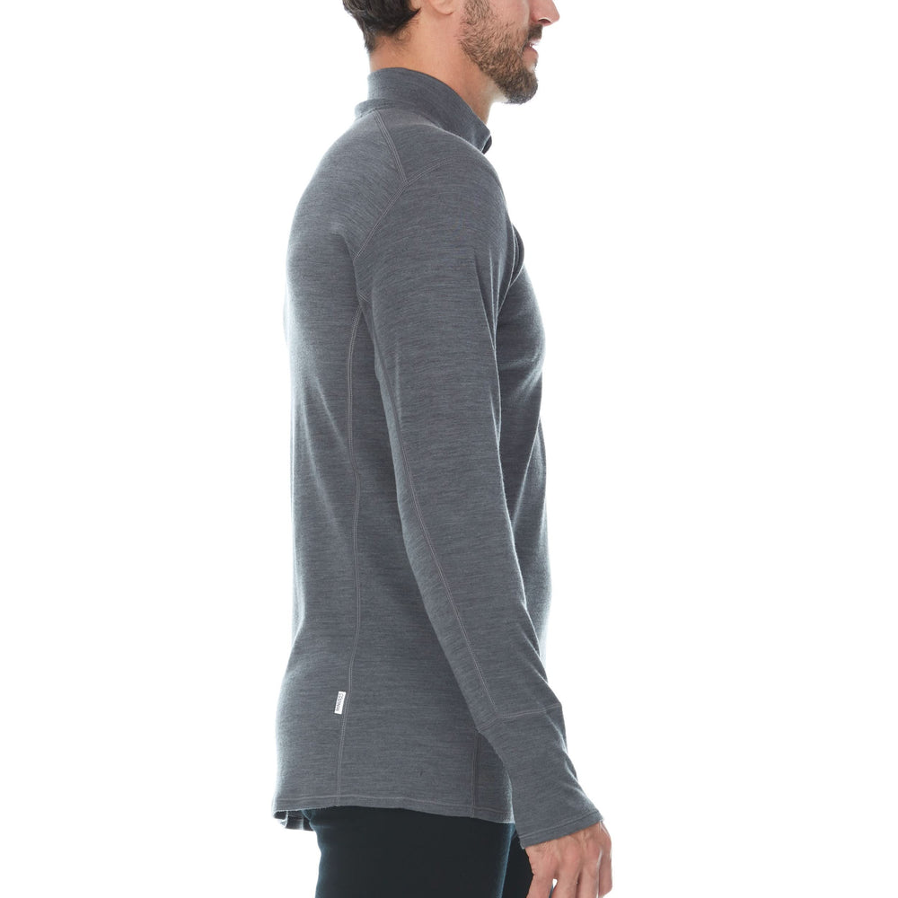 Side view of a man modeling the merino wool midweight quarter zip sweater in charcoal gray, complete with flat-lock seams and thumbholes. #color_charcoal-gray