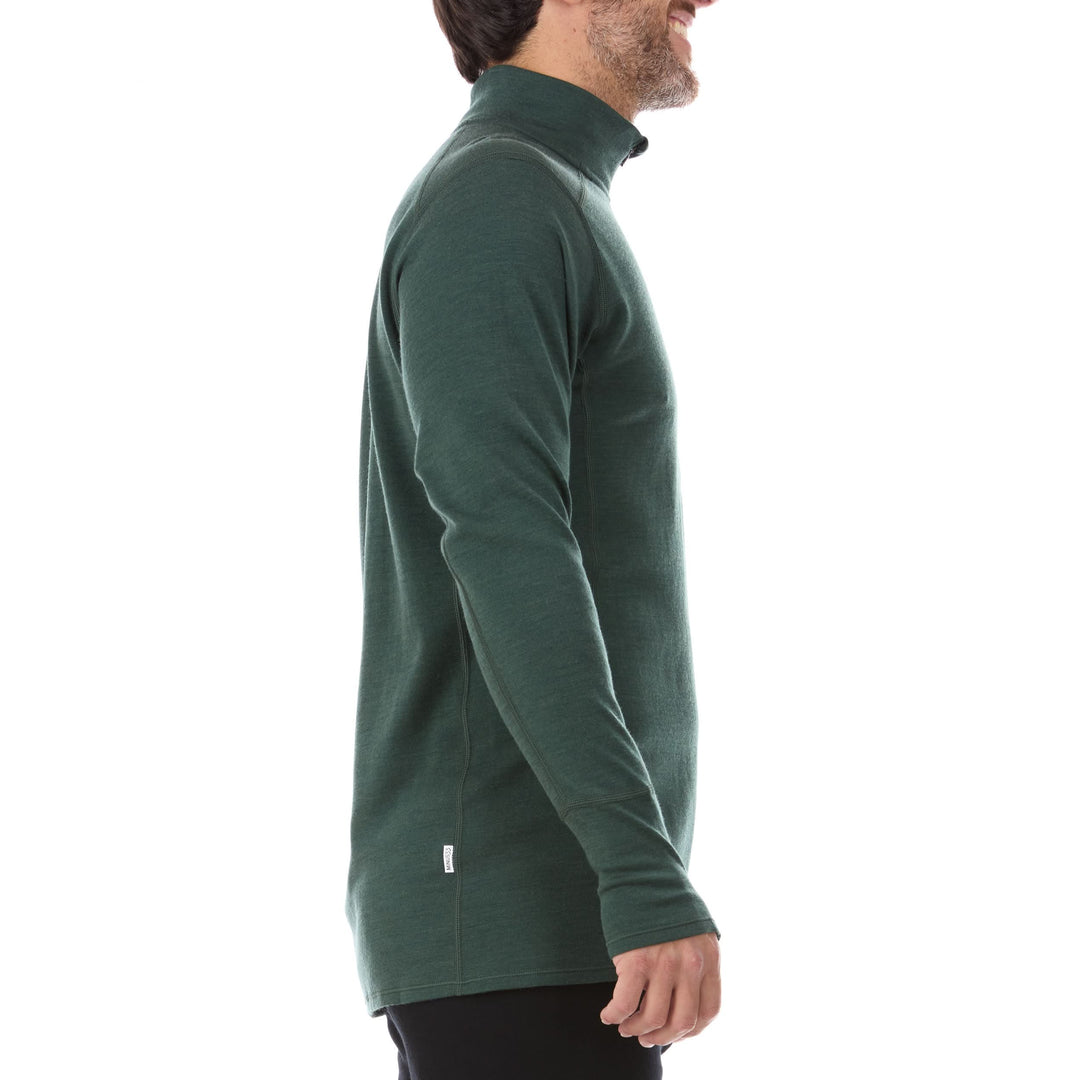A man models the merino wool midweight quarter zip sweater, complete with flat-lock seams and thumbholes, side view 
