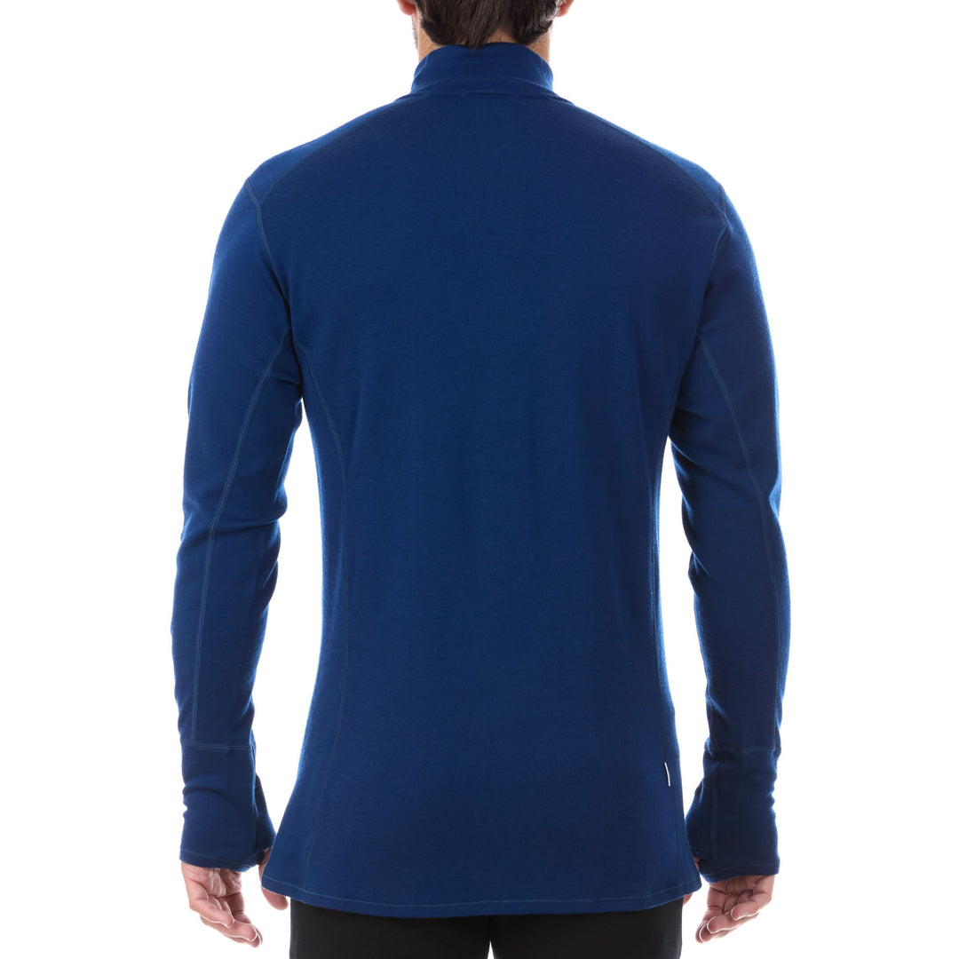 A man models the merino wool midweight quarter zip sweater, complete with flat-lock seams and thumbholes. 
