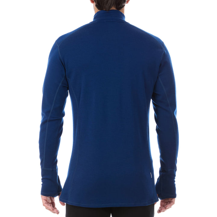 A man models the merino wool midweight quarter zip sweater, complete with flat-lock seams and thumbholes. 