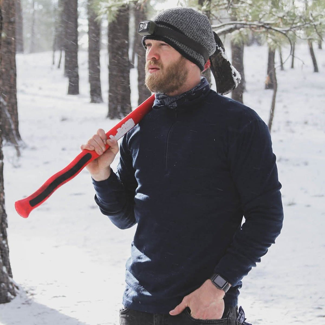 A man models the merino wool midweight quarter zip sweater, complete with flat-lock seams and thumbholes, close-up of the product 