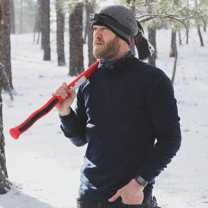 A man models the merino wool midweight quarter zip sweater, complete with flat-lock seams and thumbholes, close-up of the product 