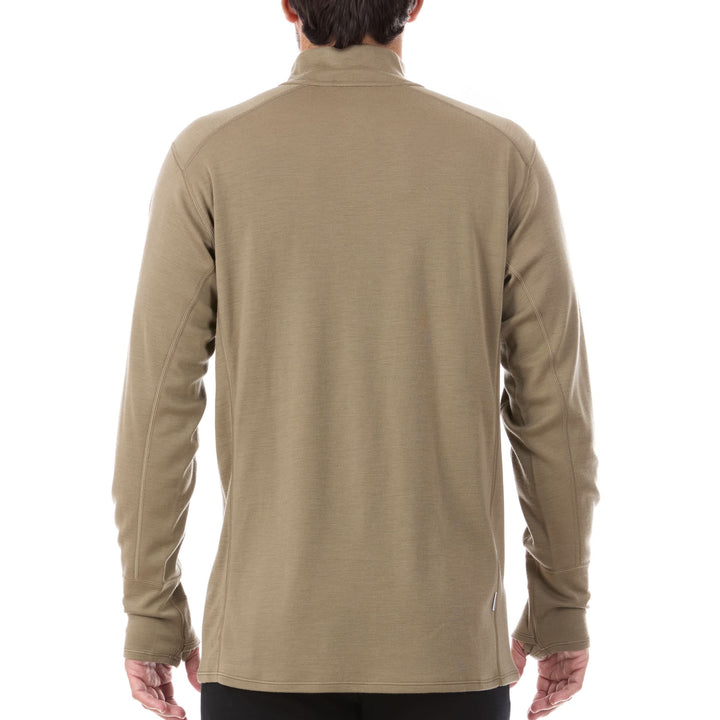 A man models the merino wool midweight quarter zip sweater, complete with flat-lock seams and thumbholes. 