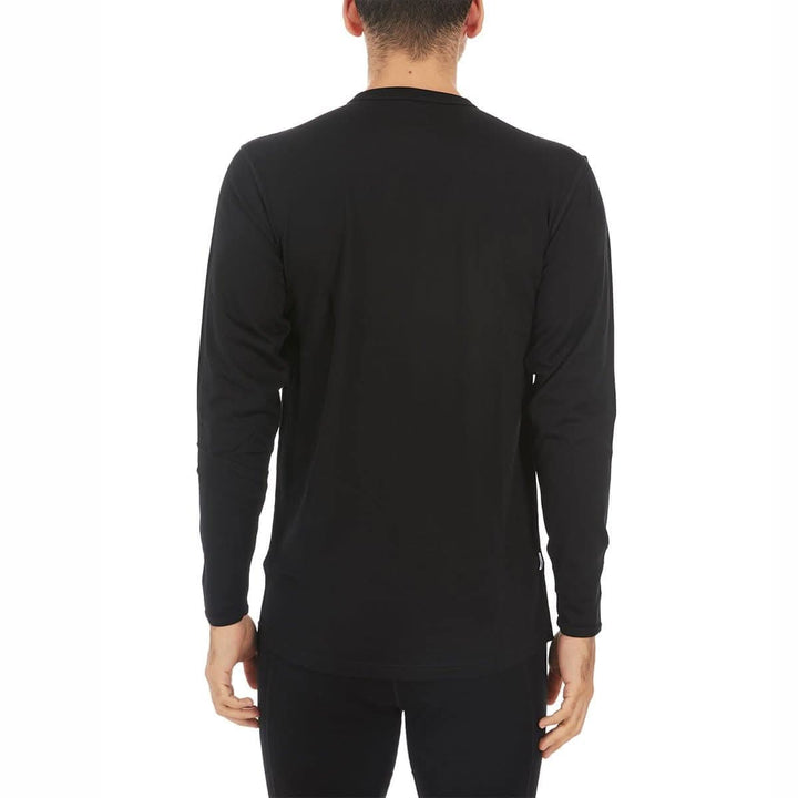 A man models the lightweight long sleeved merino wool base layer crew neck top 