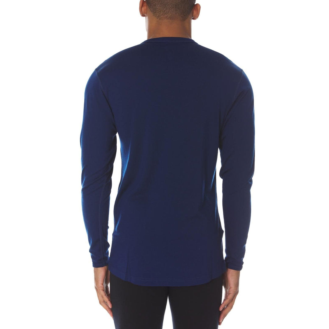 Back view of a male model wearing a navy lightweight long-sleeve merino wool crew top 