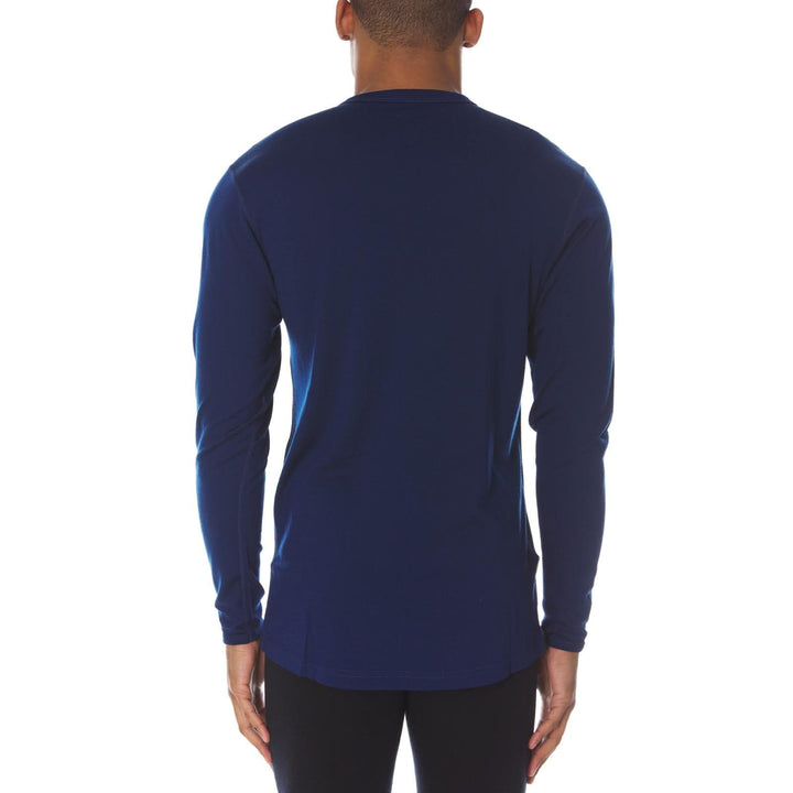 Back view of a male model wearing a navy lightweight long-sleeve merino wool crew top 