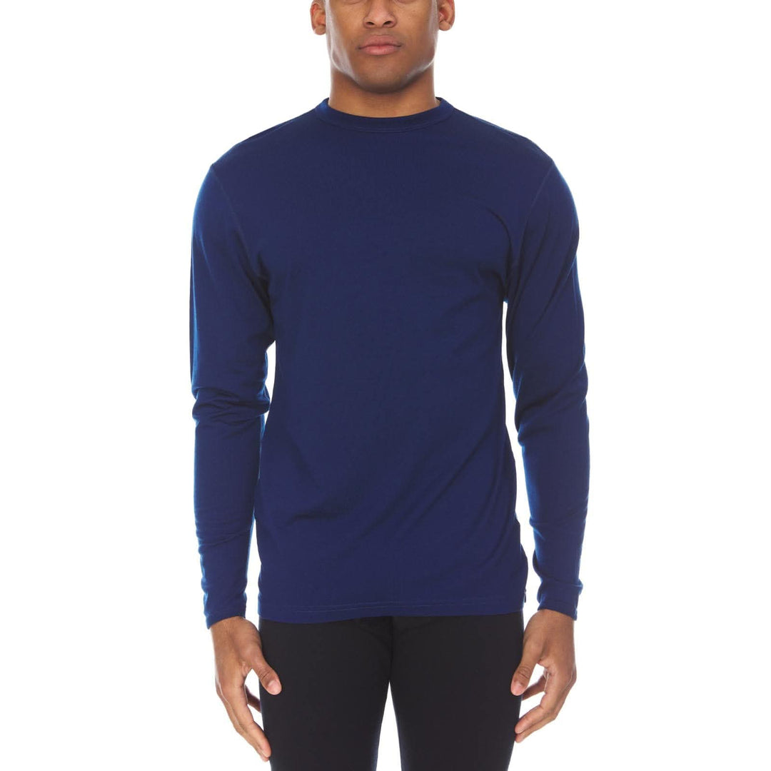 A man models the lightweight long sleeved merino wool base layer crew neck top 