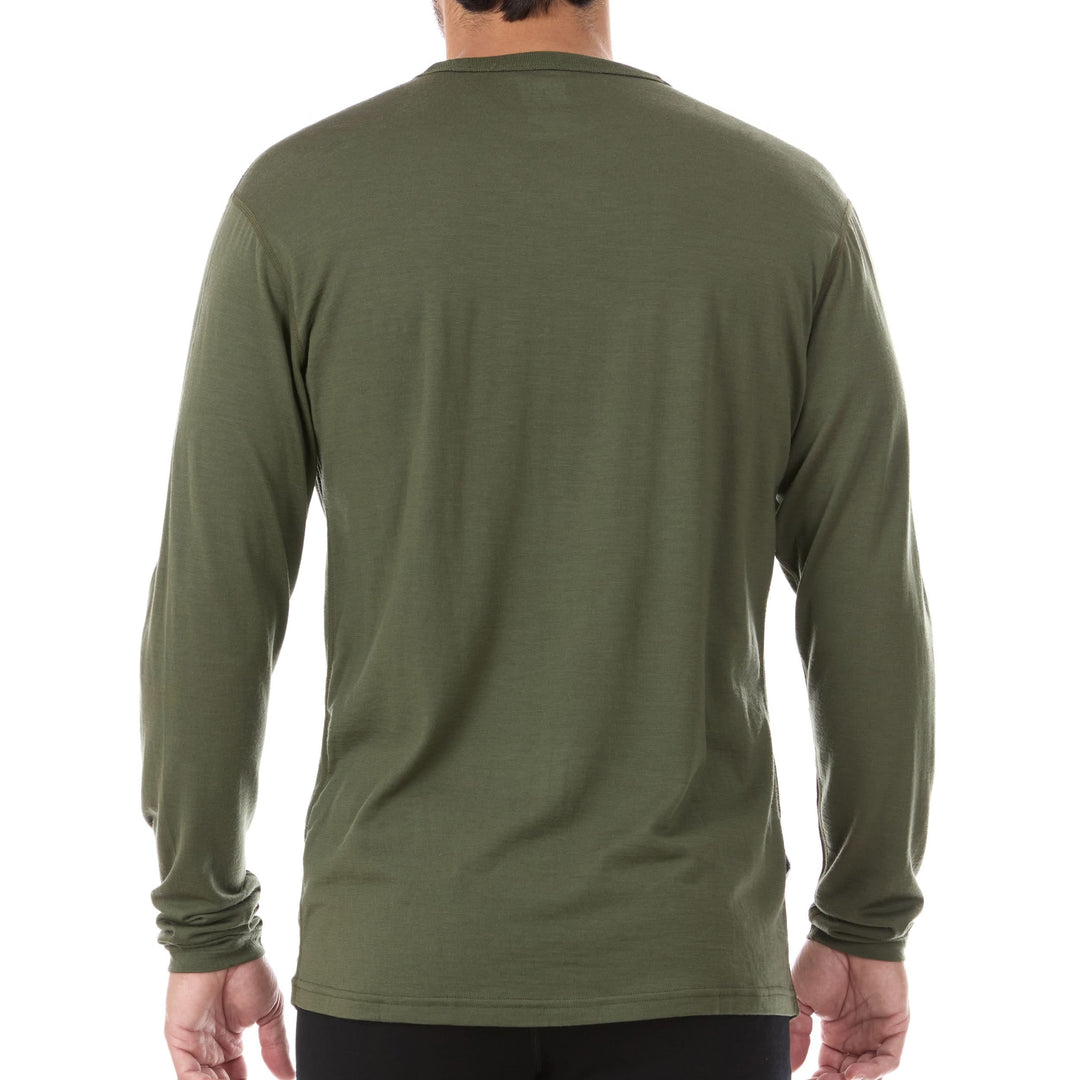 A man models the lightweight long sleeved merino wool base layer crew neck top 