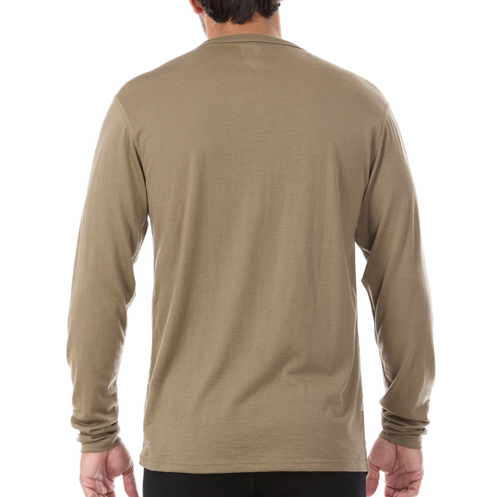 A man models the lightweight long sleeved merino wool base layer crew neck top, back view 