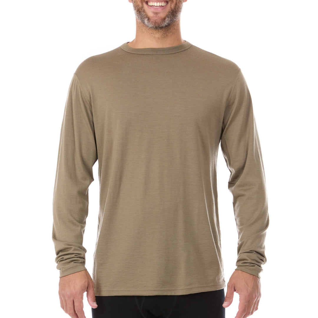 A man models the lightweight long sleeved merino wool base layer crew neck top 