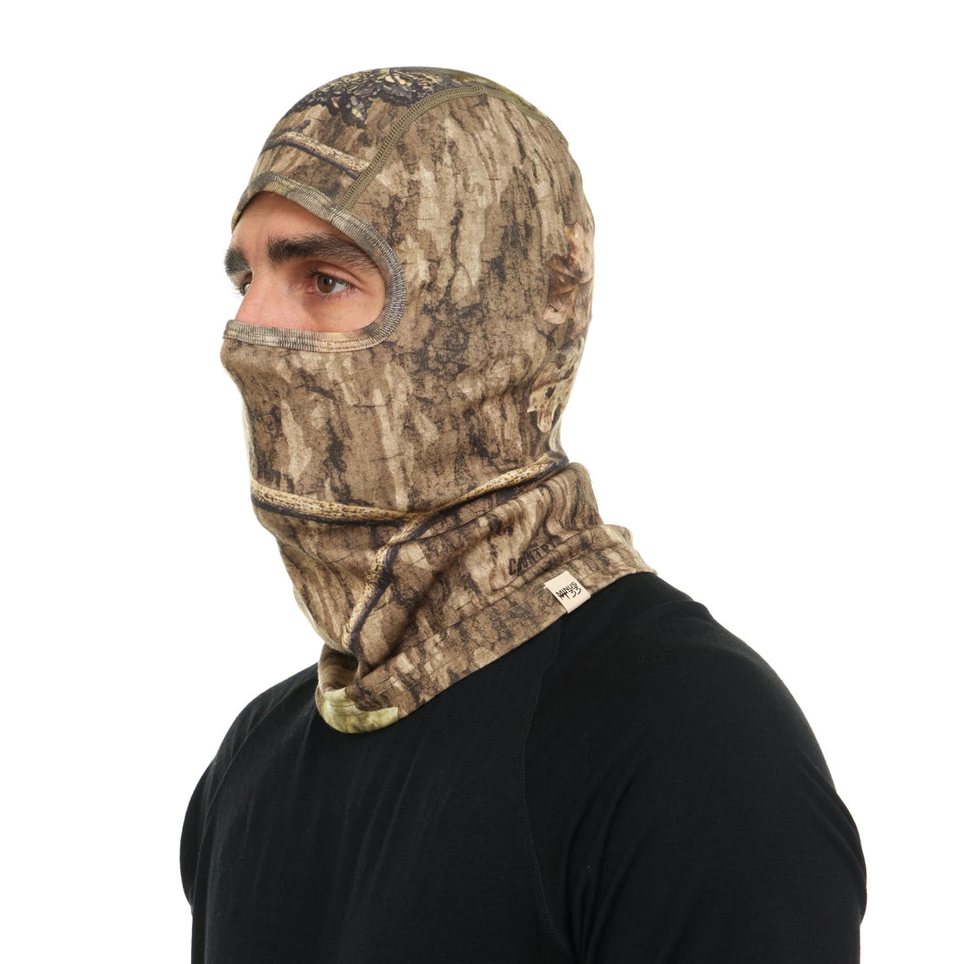 Camouflage merino wool balaclava worn over the face, side view 