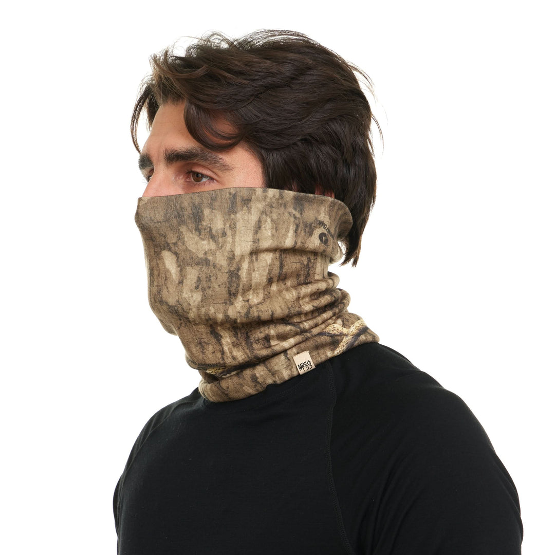 Camouflage merino wool neck gaiter pulled over the face, left-side three-quarter view 