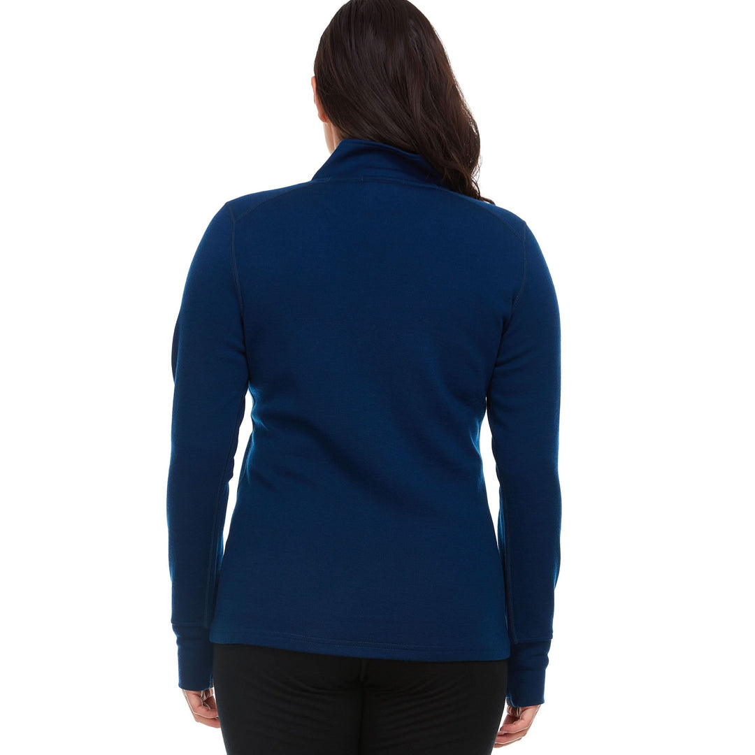 A woman models a hundred percent merino wool heavyweight full zip sweater. This outer layer features a two and a half inch mock neck collar, two zippered pockets, and thumbholes. Back view. 