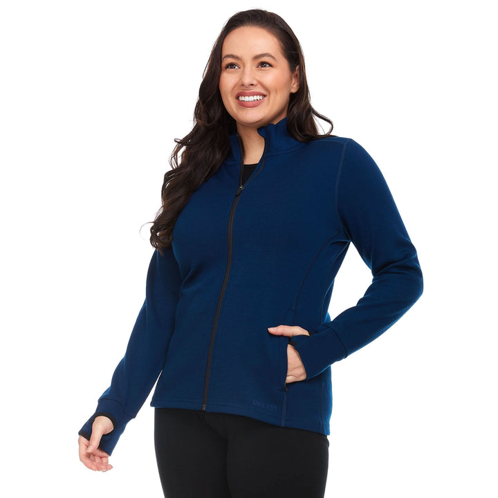 Front three-quarter view of a female model wearing a navy heavyweight merino wool full-zip sweater with mock neck, zip pockets, and thumbholes 