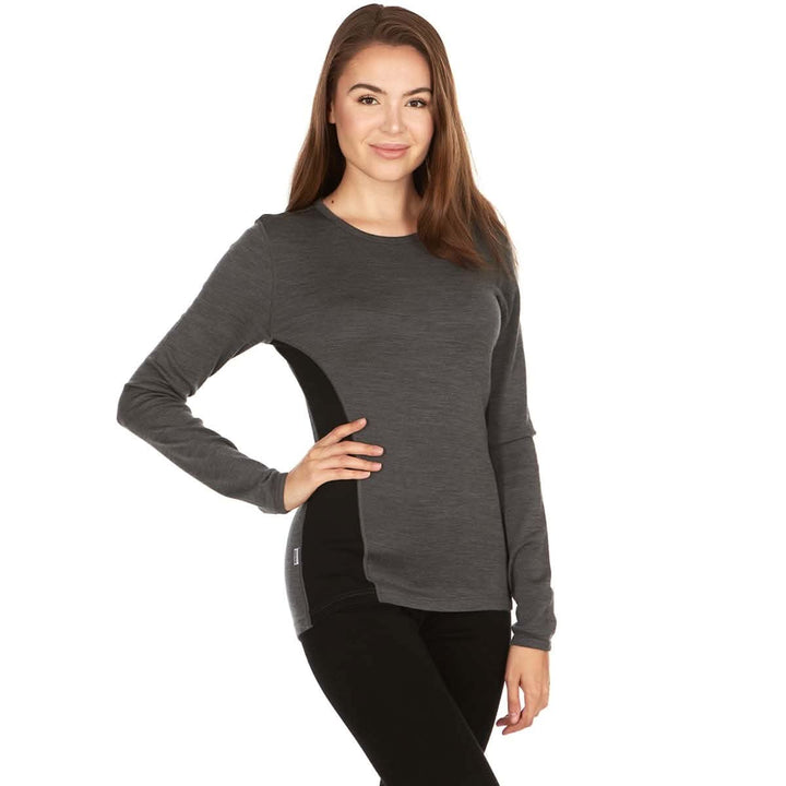 A woman models a soft, 100% merino wool, midweight base layer crew top. The women&
