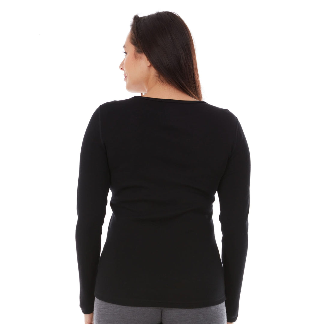 A woman models a soft, 100% merino wool, midweight base layer crew top. The women&