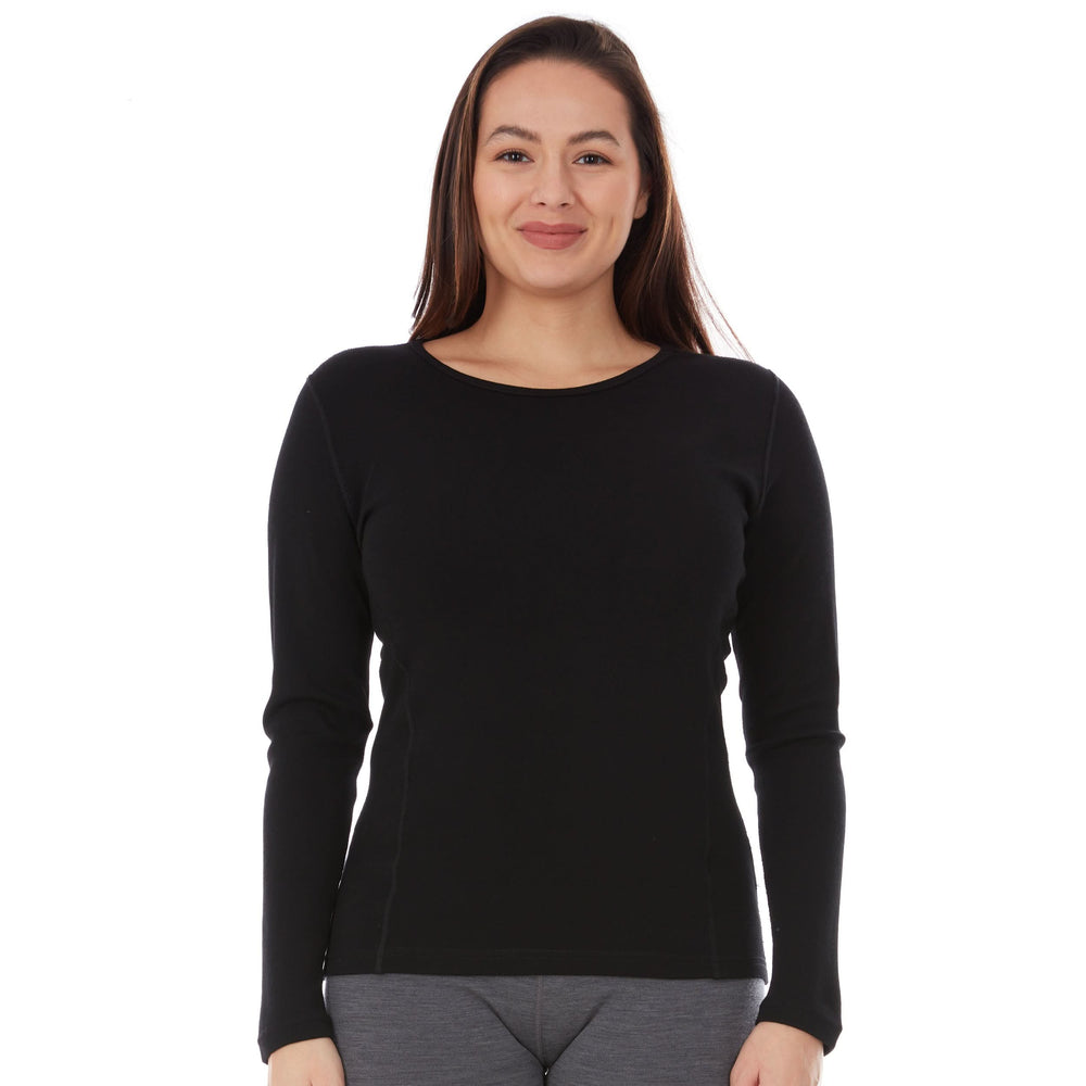 A woman models a soft, 100% merino wool, midweight base layer crew top. The women's midweight base layer crew features a princess cut for a more flattering fit, front view #color_black
