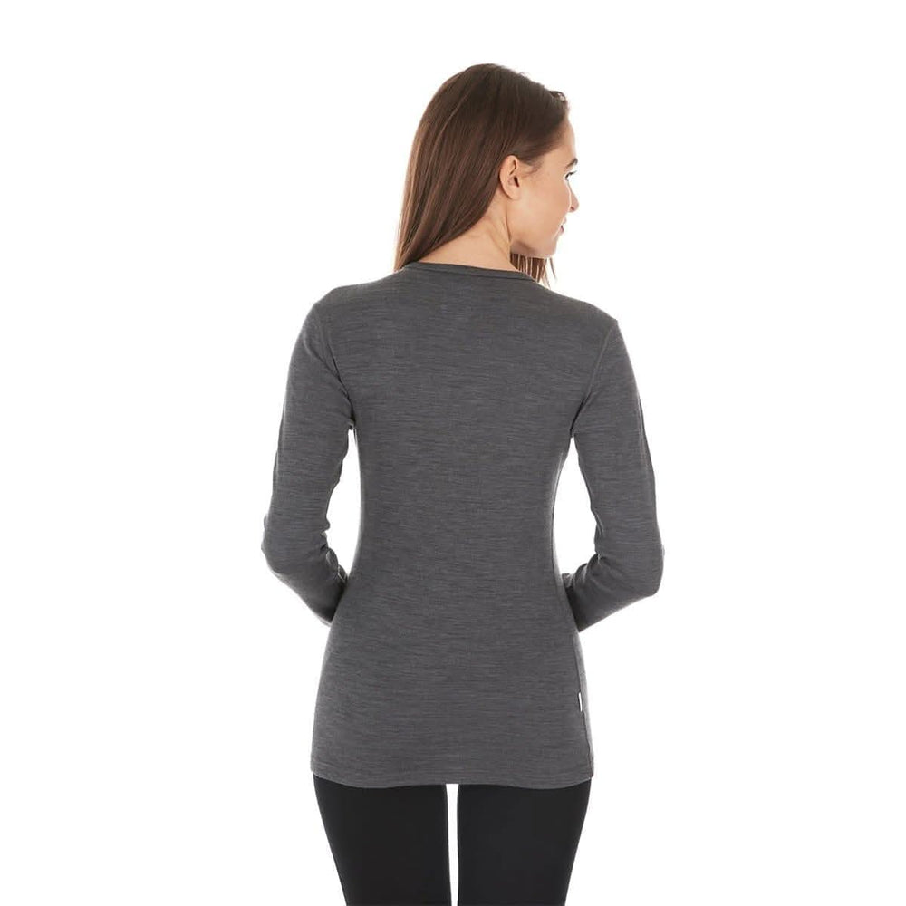 A woman models a soft, 100% merino wool, midweight base layer crew top. The women's midweight base layer crew features a princess cut for a more flattering fit. Back view. #color_charcoal-gray