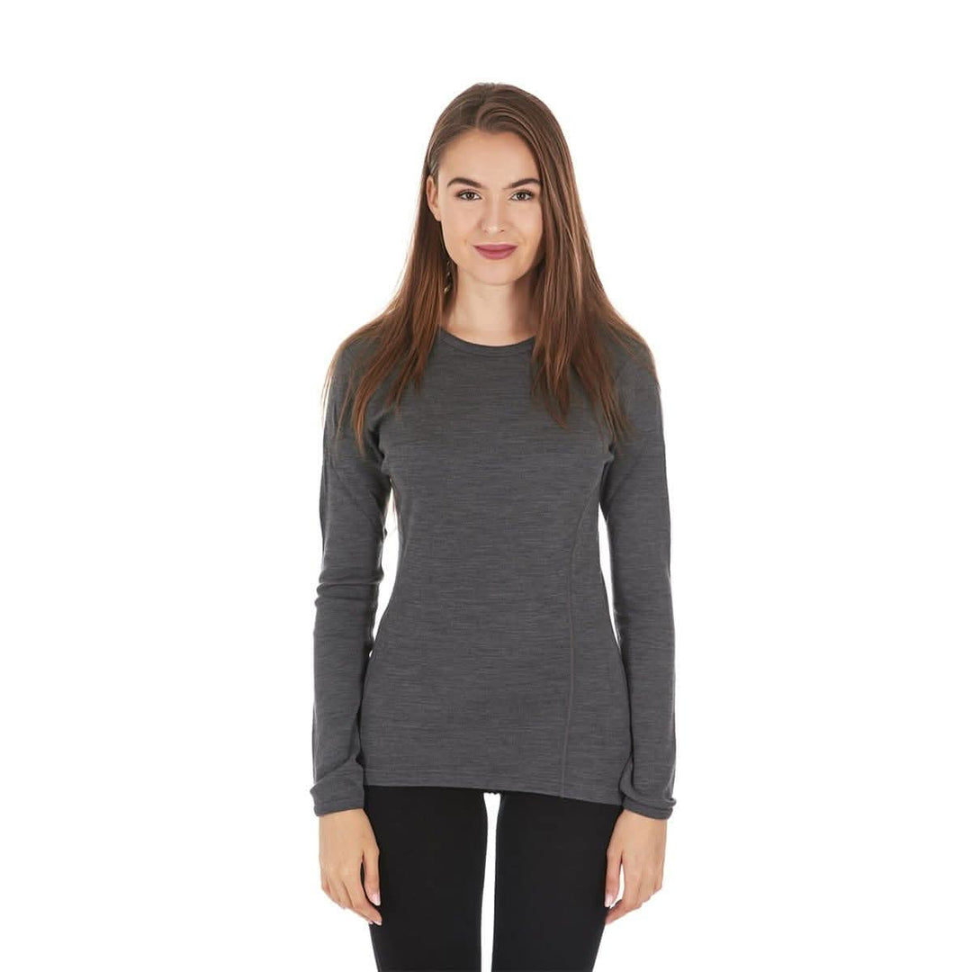 A woman models a soft, 100% merino wool, midweight base layer crew top. The women's midweight base layer crew features a princess cut for a more flattering fit. Front view 1. #color_charcoal-gray