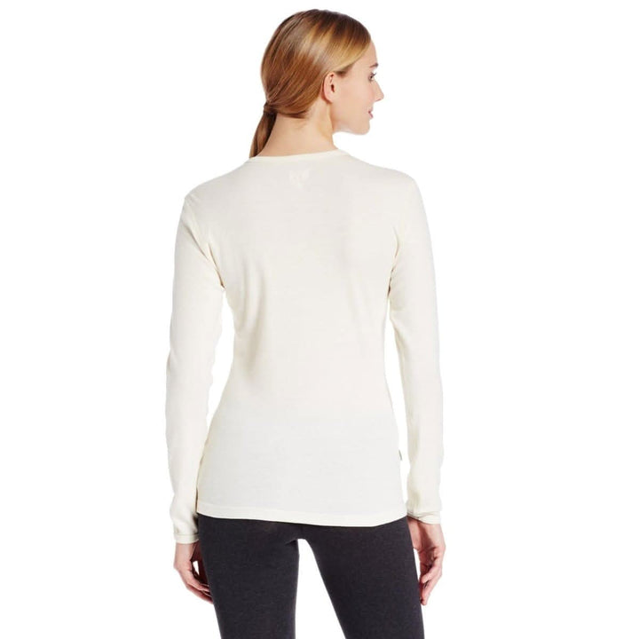 A woman models a soft, 100% merino wool, midweight base layer crew top. The women&