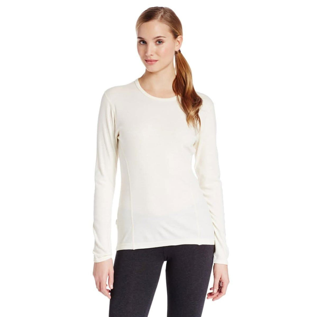 A woman models a soft, 100% merino wool, midweight base layer crew top. The women&