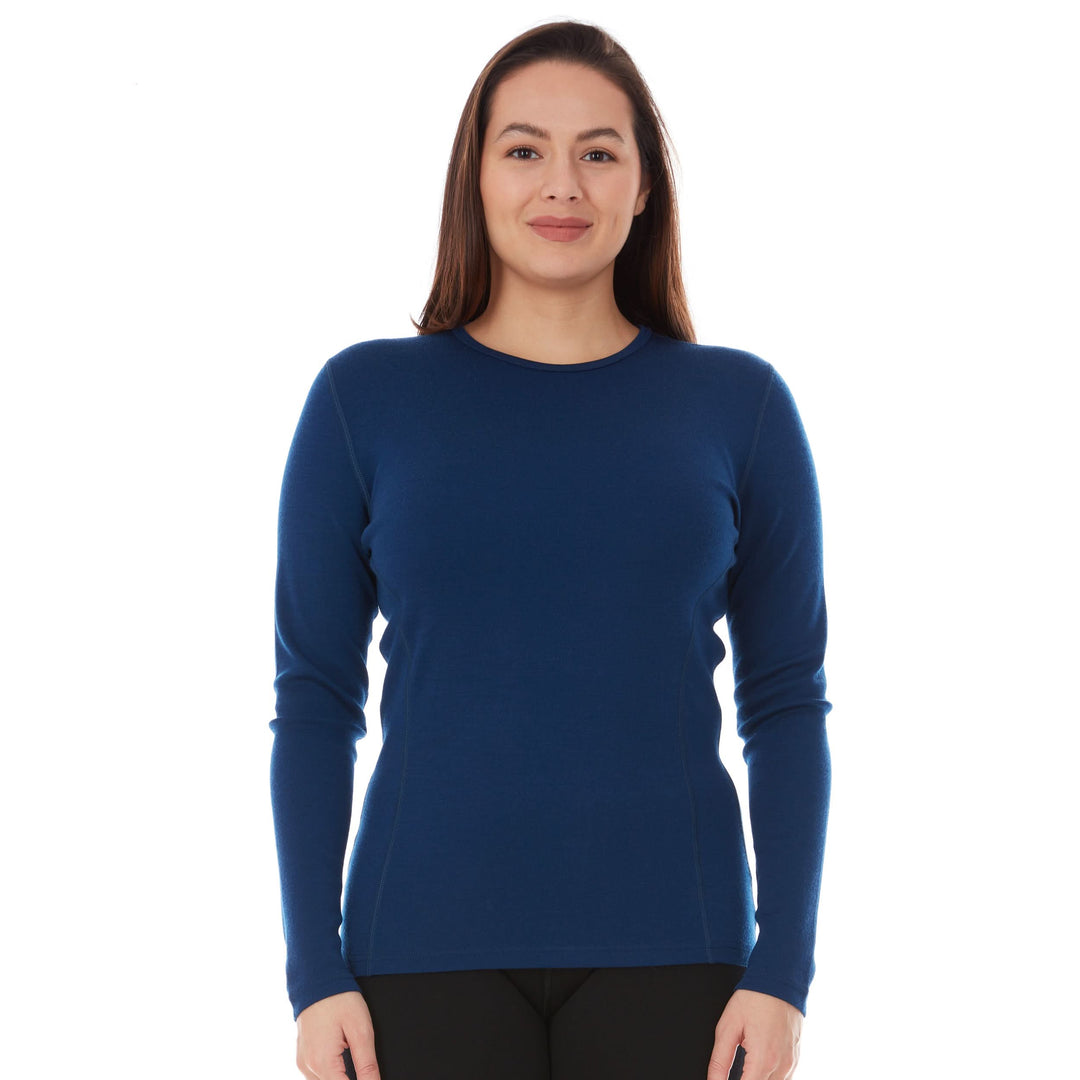 A woman models a soft, 100% merino wool, midweight base layer crew top. The women&