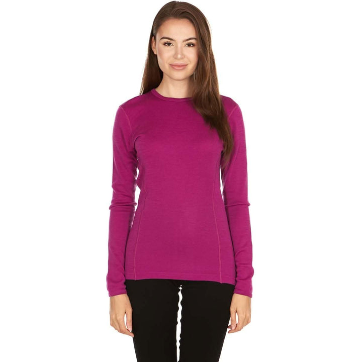A woman models a soft, 100% merino wool, midweight base layer crew top. The women&