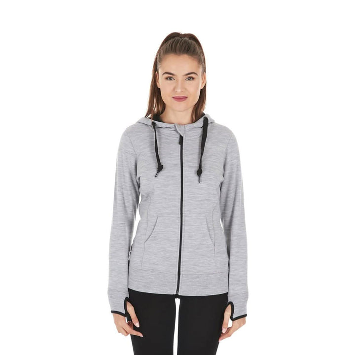 A woman models the heavyweight merino wool brushed fleece hoodie. The hoodie features a large hood with drawstrings, thumbholes, two pockets, and an interior stash pocket inside. Front view 1. 