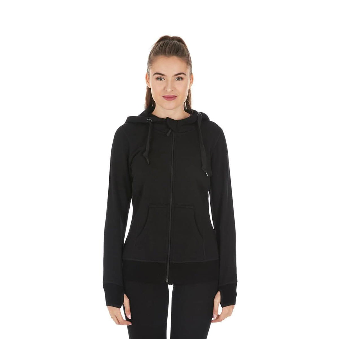A woman models the heavyweight merino wool brushed fleece hoodie. The hoodie features a large hood with drawstrings, thumbholes, two pockets, and an interior stash pocket inside, front view 