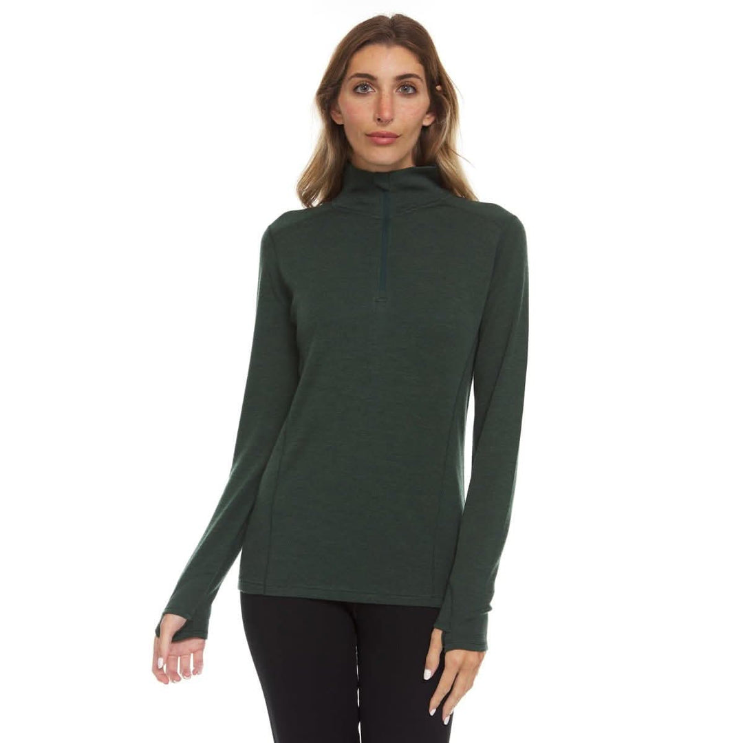 A woman models a comfortable women's midweight quarter zip sweater in a soft merino wool. The sweater features a 1/4 zip neckline and thumbholes at the cuffs. Front view 1. #color_forest-green
