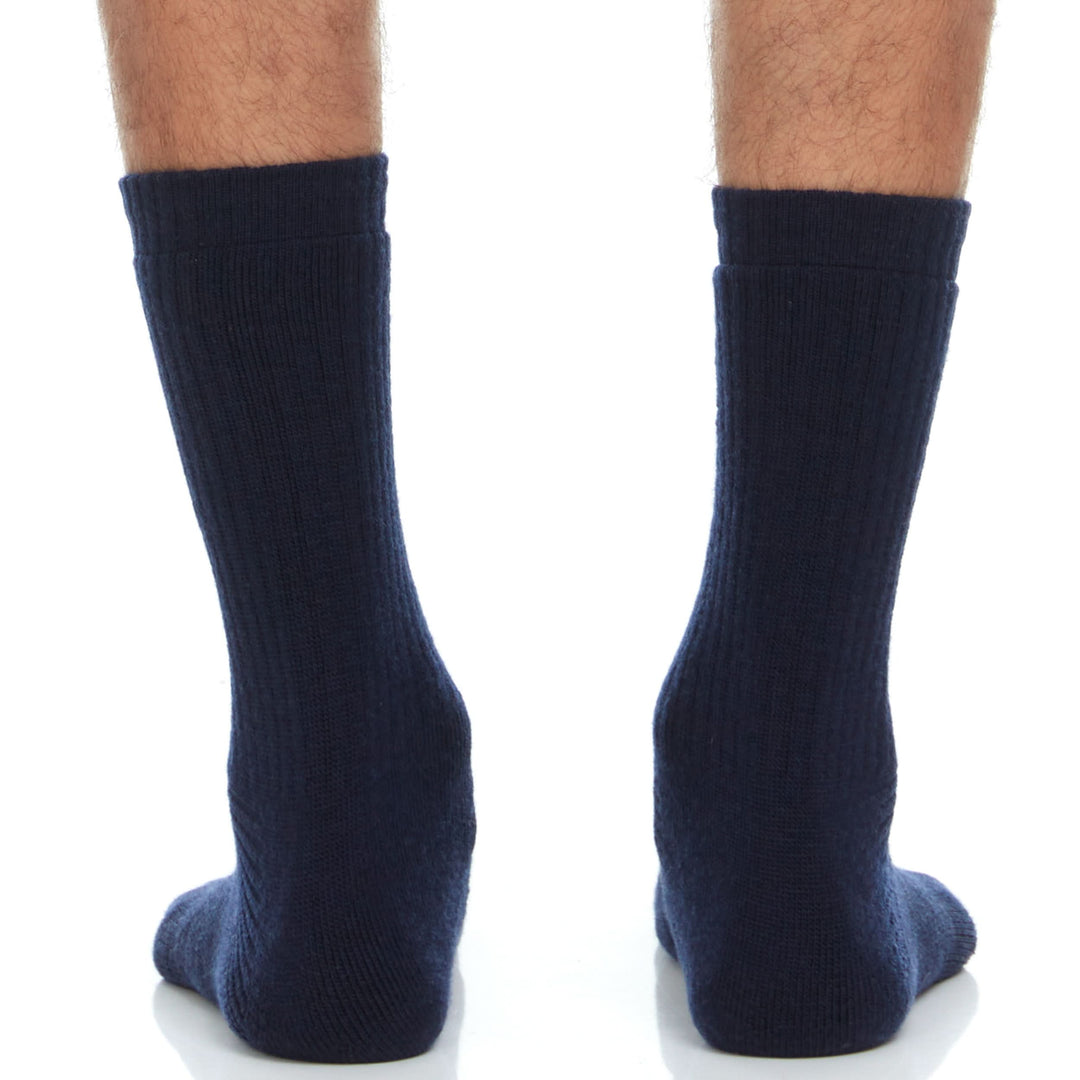 Front view of navy midweight merino wool Workhorse crew socks laid flat, showing the ribbed crew-height legs, supportive ankle sections, cushioned footbeds, and reinforced toes