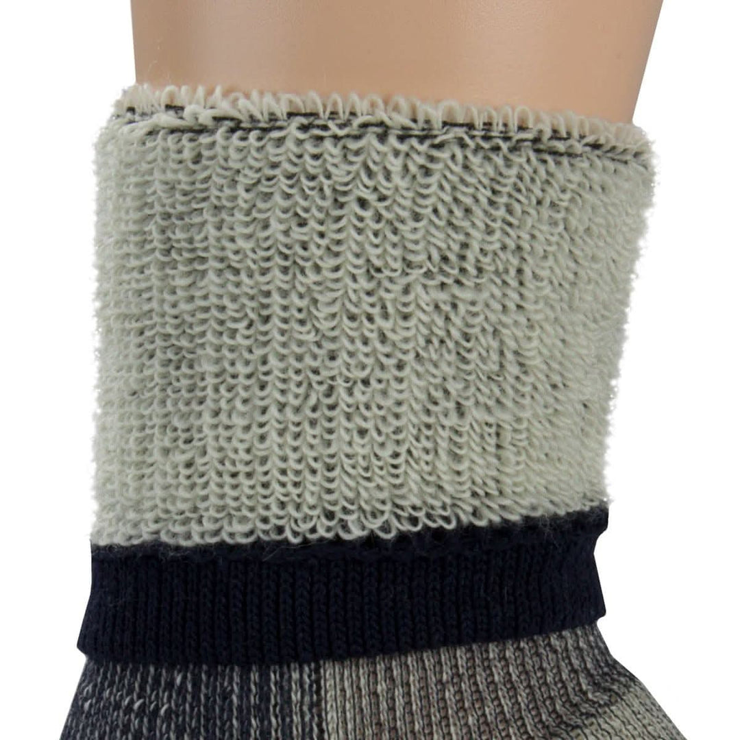 Macro inside-out view of a denim heather merino wool day-hiker sock cuff on a leg form, showing dense light gray looped terry cushioning above a navy ribbed support band and two-tone gray lower knit 