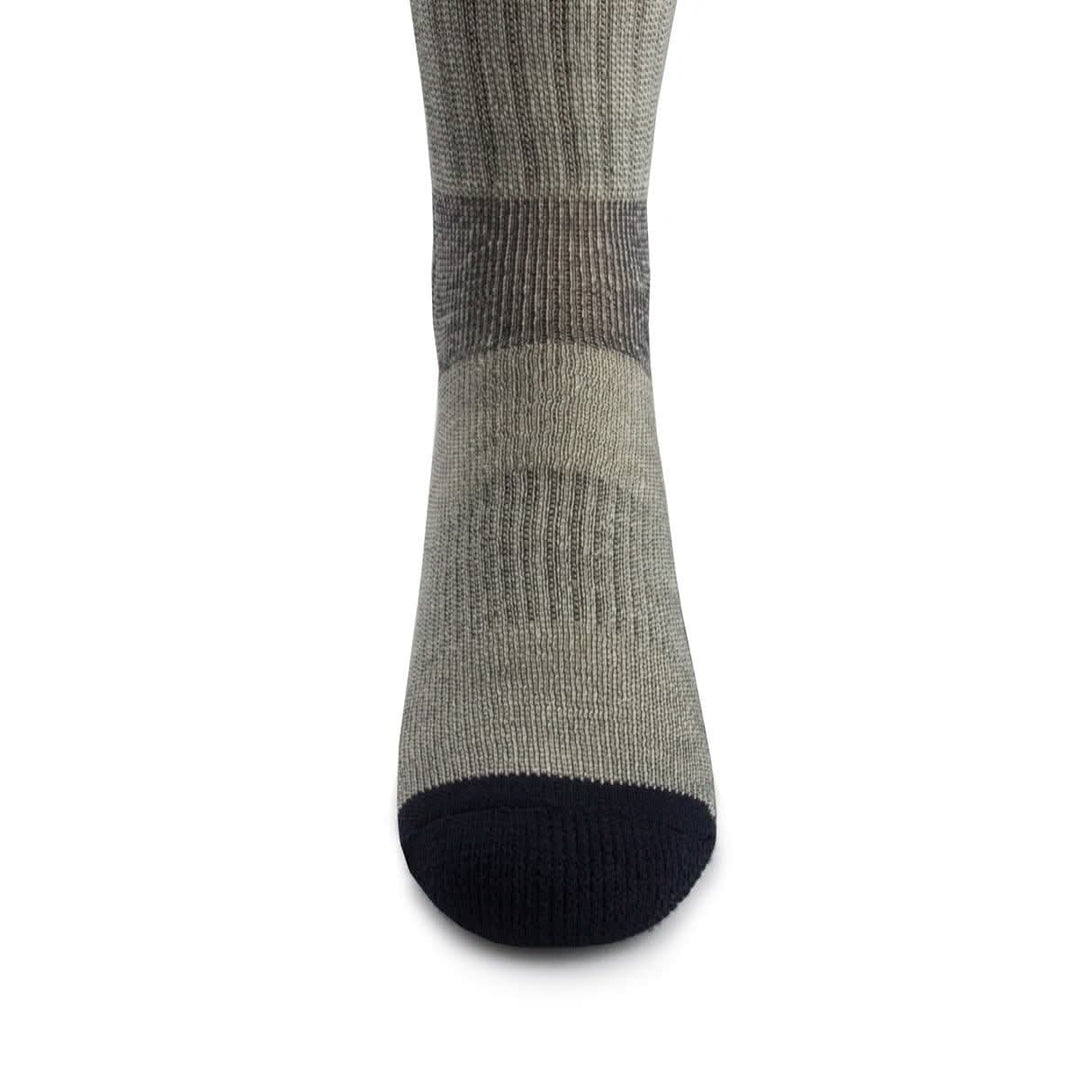 Front close-up view of a denim heather merino wool day-hiker sock on a foot form, highlighting the navy reinforced rounded toe, vertical ribbed ventilation panel over the forefoot, and dark gray fitted arch band 