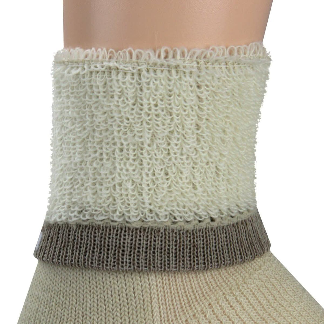 Macro inside-out view of a natural cream merino wool day-hiker sock cuff on a leg form, showing plush cream looped terry cushioning above a taupe ribbed support band and smooth natural knit below 