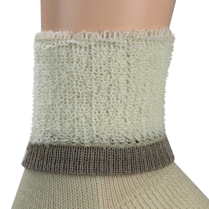 Macro inside-out view of a natural cream merino wool day-hiker sock cuff on a leg form, showing plush cream looped terry cushioning above a taupe ribbed support band and smooth natural knit below 