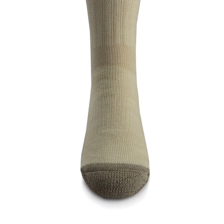 Front close-up view of a natural cream merino wool day-hiker sock on a foot form, highlighting the taupe reinforced rounded toe, vertical ribbed ventilation panel over the forefoot, and fitted ankle section 