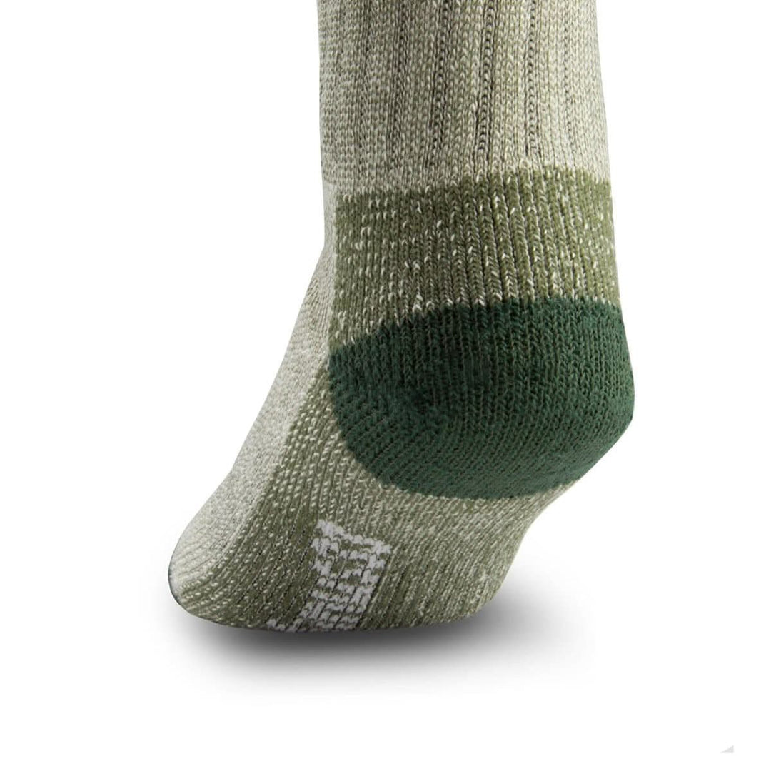 Side close-up view of an olive green merino wool day-hiker sock on a foot form, emphasizing the rounded dark forest green reinforced heel, olive ribbed ankle panel, textured arch support, and white Minus33 forefoot logo 