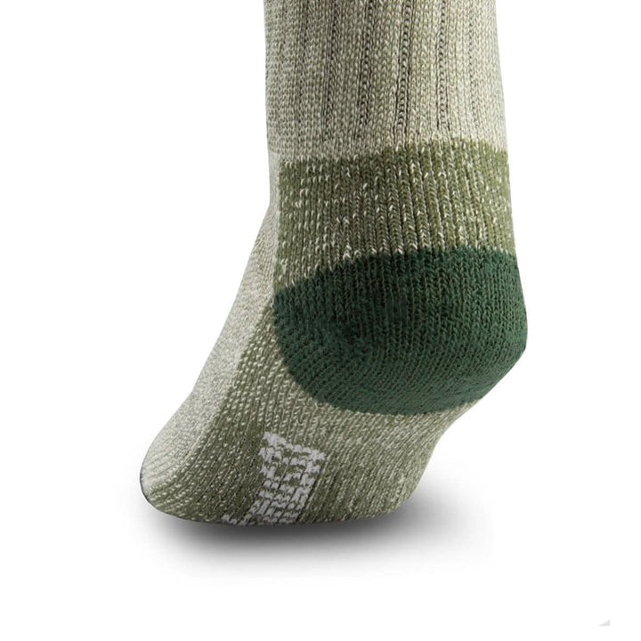 Side close-up view of an olive green merino wool day-hiker sock on a foot form, emphasizing the rounded dark forest green reinforced heel, olive ribbed ankle panel, textured arch support, and white Minus33 forefoot logo 