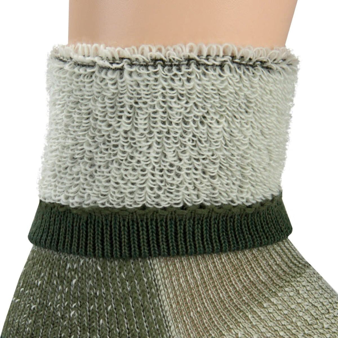 Macro inside-out view of an olive green merino wool day-hiker sock cuff on a leg form, showing thick light gray looped terry cushioning above a dark forest green ribbed support band and olive lower knit 