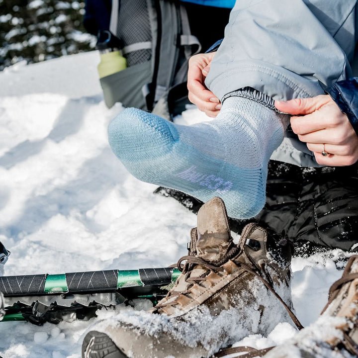 Midweight - Day Hiker Crew Socks - Minus33 Merino Wool Clothing, powder-blue socked foot in snow beside a hiking boot