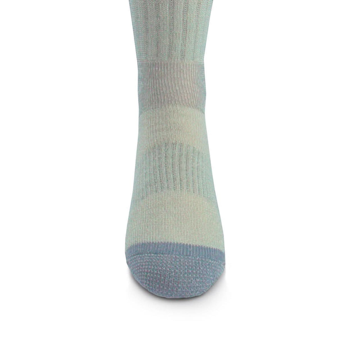 Front close-up view of a powder blue merino wool day-hiker sock on a foot form, highlighting the darker blue reinforced rounded toe, vertical ribbed ventilation panel over the forefoot, and fitted ankle knit 