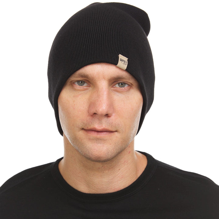 A man models a heavyweight, super soft, one hundred percent merino wool beanie. This heavyweight beanie is the warmest hat that we offer, perfect for hiking through the White Mountains, or sitting at a bonfire in January, front view 