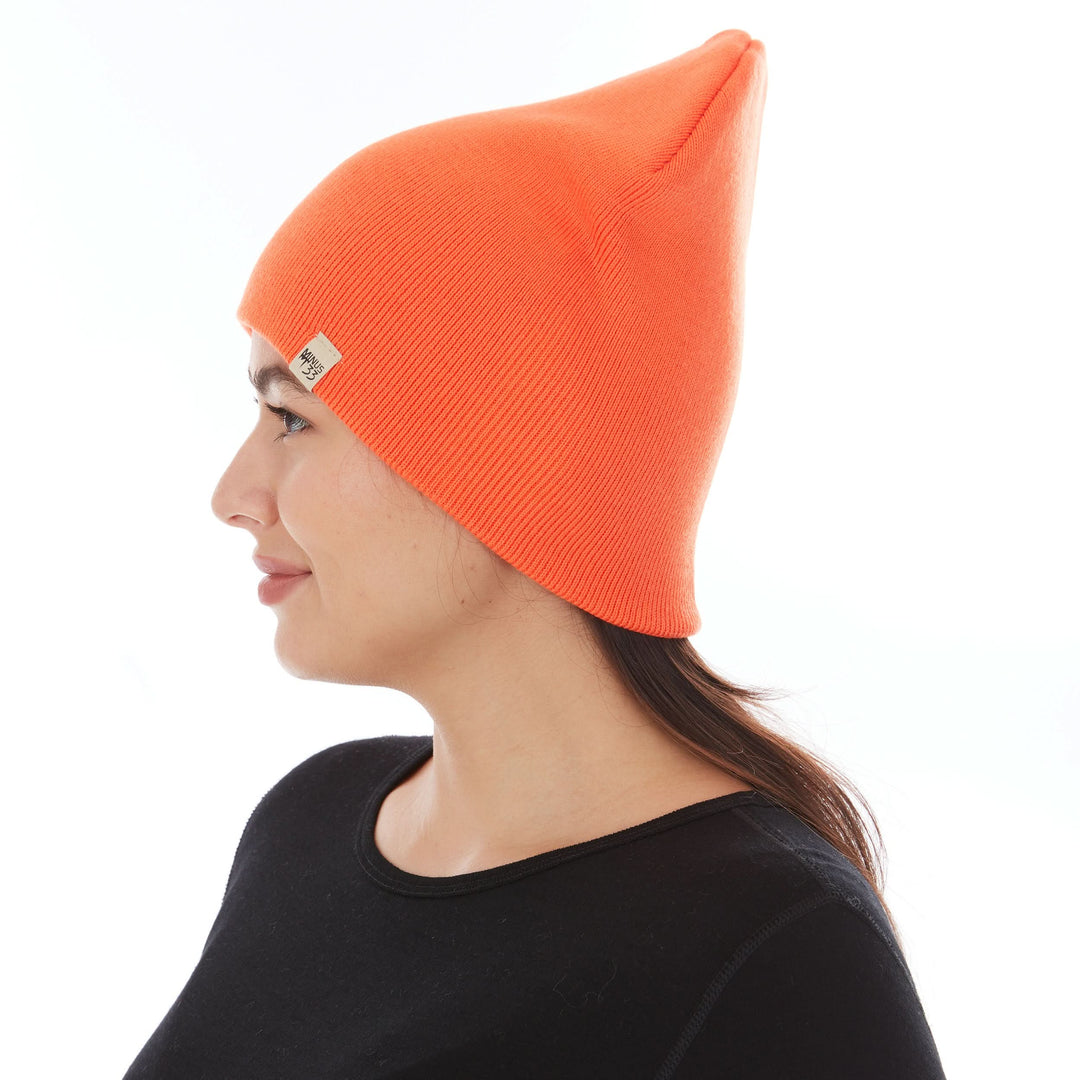 A woman models a heavyweight, super soft, one hundred percent merino wool beanie. This heavyweight beanie is the warmest hat that we offer, perfect for hiking through the White Mountains, or sitting at a bonfire in January, right-facing side view 