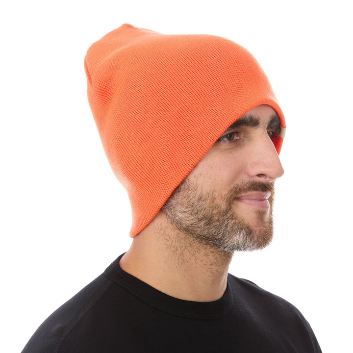 A man models a heavyweight, super soft, one hundred percent merino wool beanie. This heavyweight beanie is the warmest hat that we offer, perfect for hiking through the White Mountains, or sitting at a bonfire in January. 