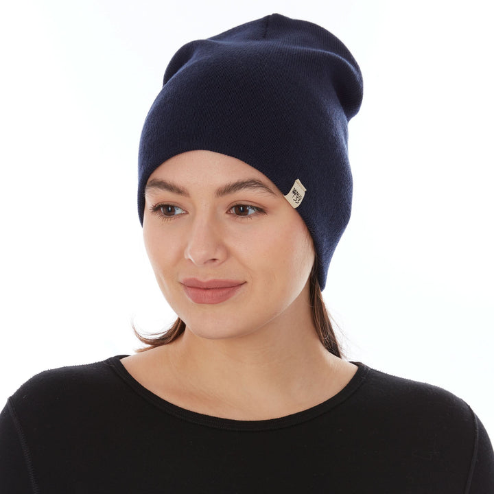A woman models a heavyweight, super soft, one hundred percent merino wool beanie. This heavyweight beanie is the warmest hat that we offer, perfect for hiking through the White Mountains, or sitting at a bonfire in January, front view 