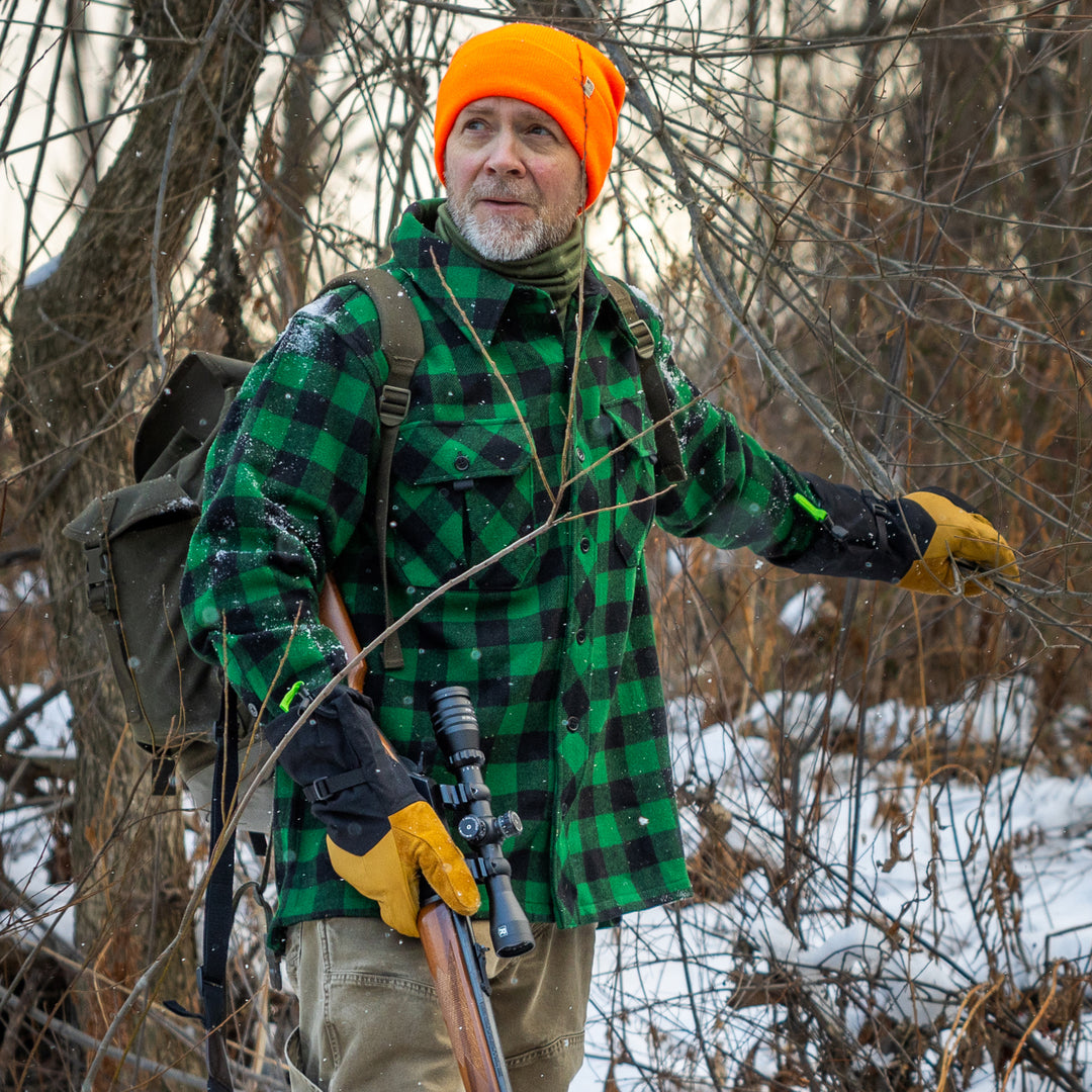 Hunter in Maine on a snowy day wearing a green Plaid Wool Shirt Jacket 