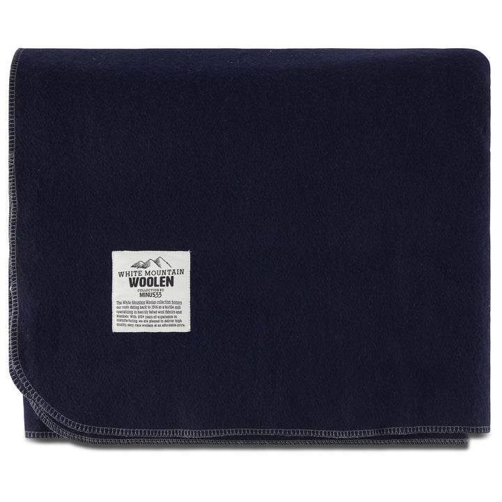 Folded navy king wool blanket with White Mountain Woolen label 
