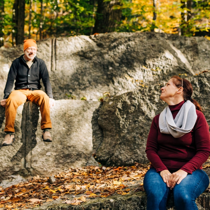 Midweight - Everyday Knit Infinity Loop Scarf 100% Merino Wool - Minus33 Merino Wool Clothing, woman seated on a boulder looking toward a man 