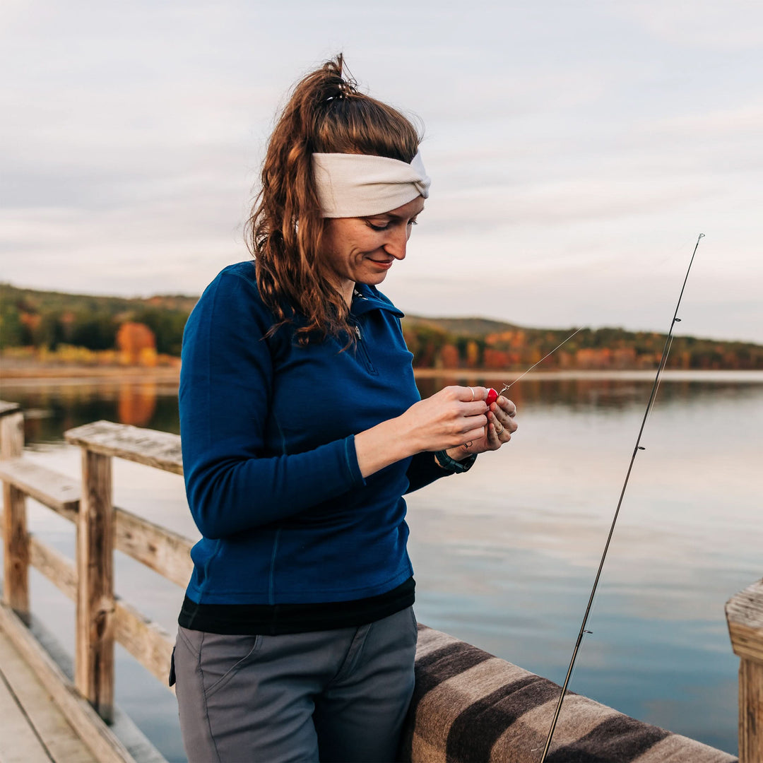 Midweight - Everyday Knit Twist Headband 100% Merino Wool - Minus33 Merino Wool Clothing, woman tying fishing line on a lakeside dock 